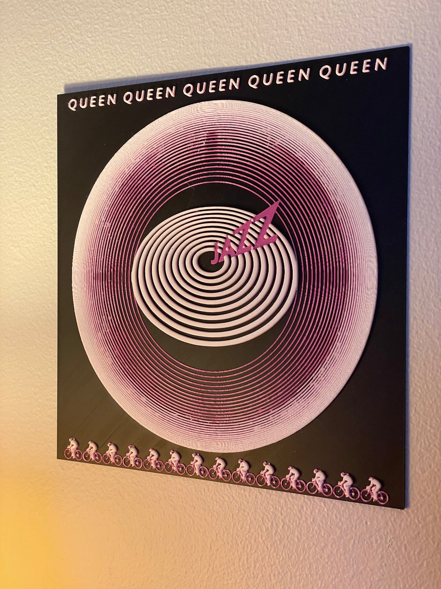 Album cover with spiral design and 'Queen' branding on a gradient background