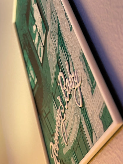 Close-up of a framed poster text on a plain background