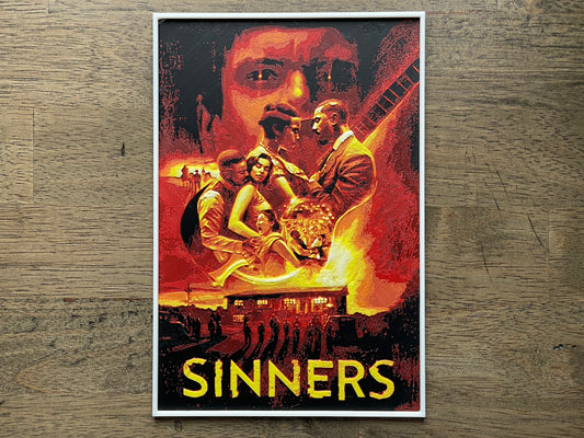 Movie poster for 'Sinners' on a wooden surface