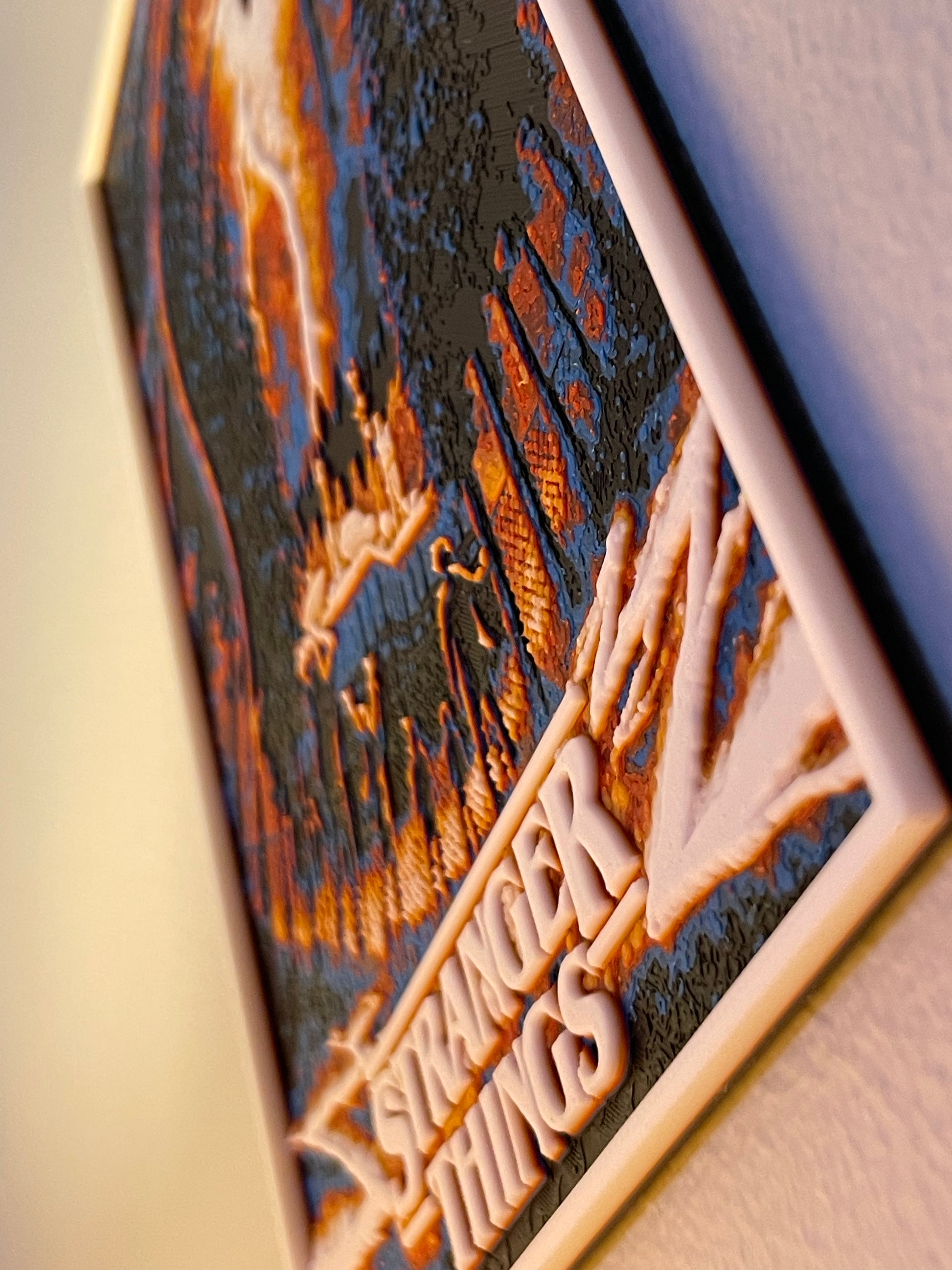 Decorative plaque with 'Stranger Things' text and artistic design on a textured surface