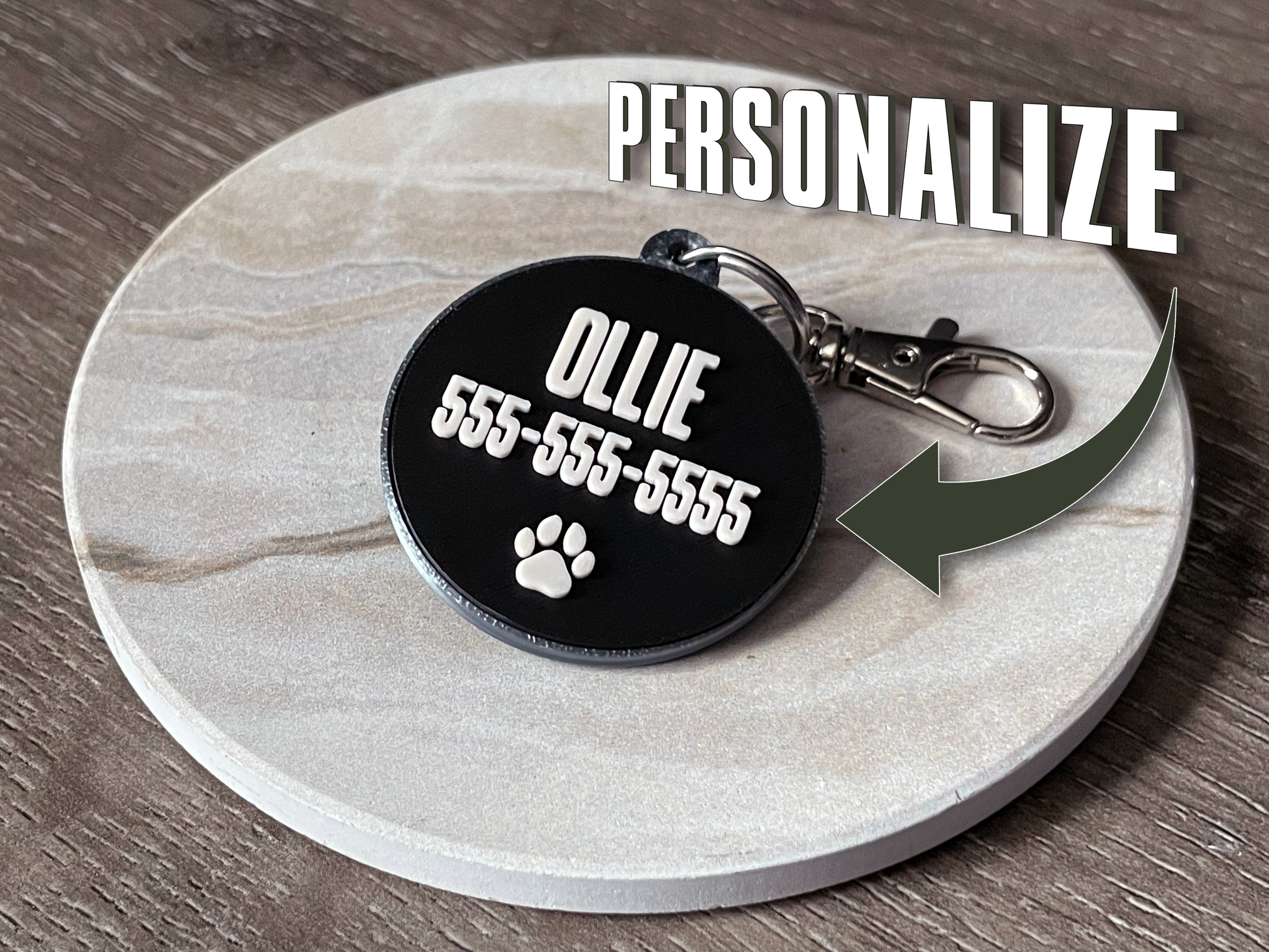 Personalized pet tag with name and phone number on a marble coaster