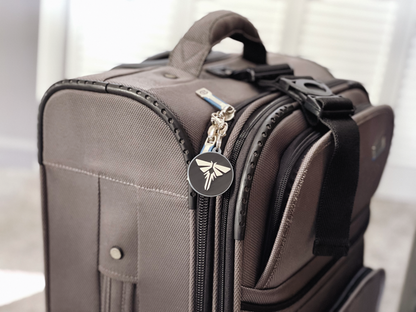 Brown suitcase with a visible brand logo on a light background