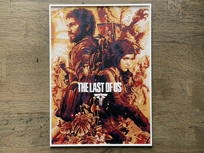 Poster of 'The Last of Us' game on a wooden surface