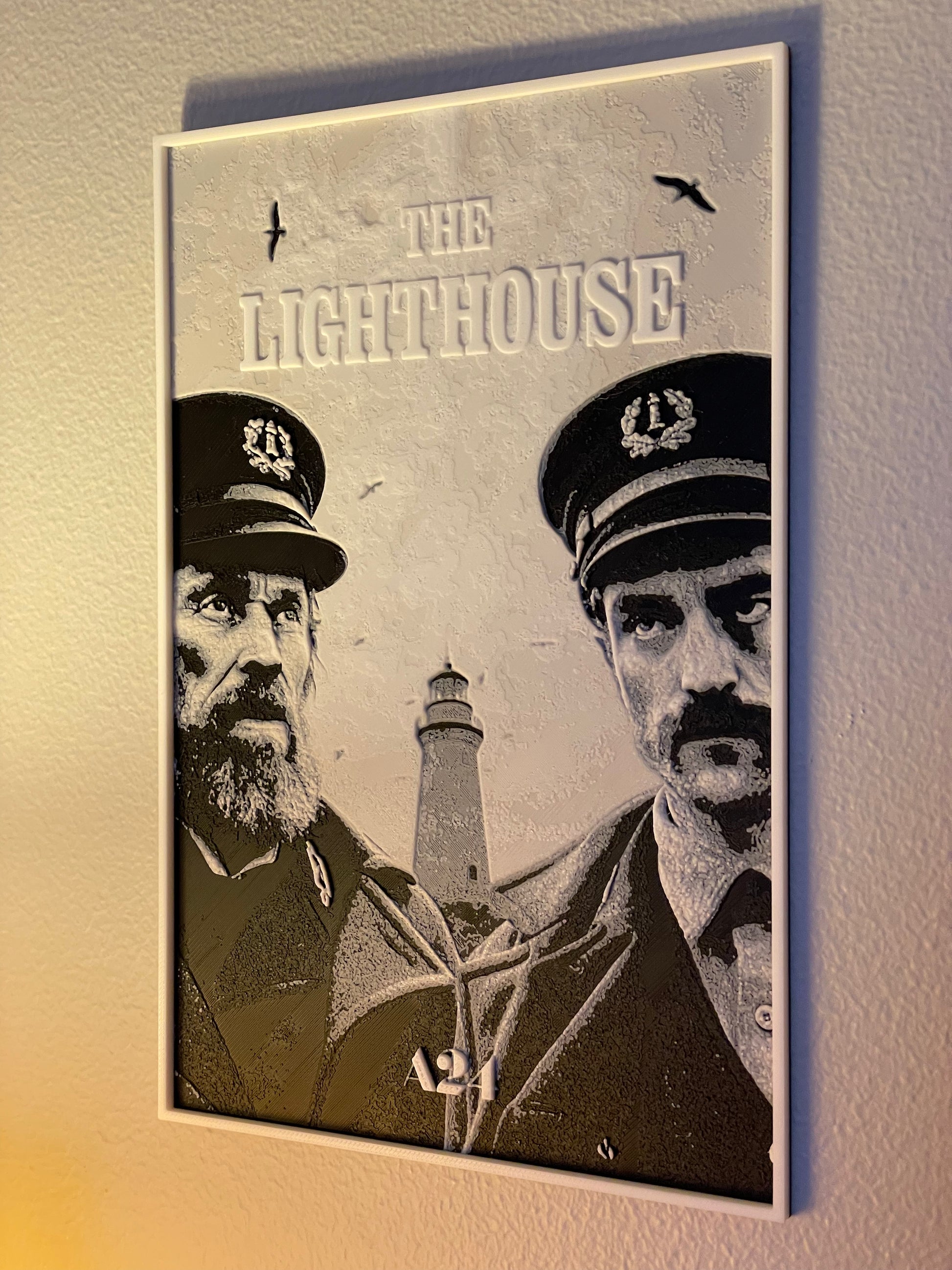 Poster of 'The Lighthouse' with two men in uniform and a lighthouse in the background.