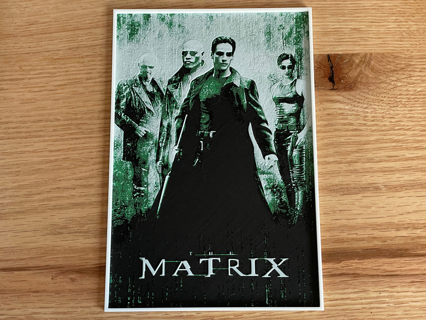 Movie poster for 'The Matrix' on a wooden surface
