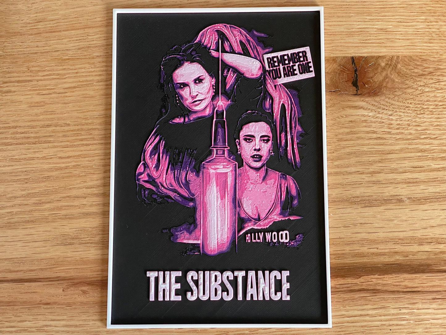 Poster with artistic design of a woman and text on a wooden surface