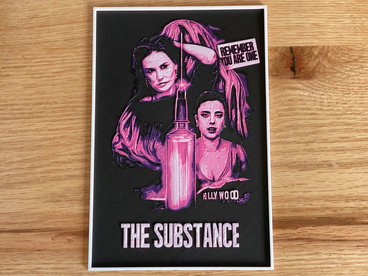 Poster with artistic design of a woman and text on a wooden surface