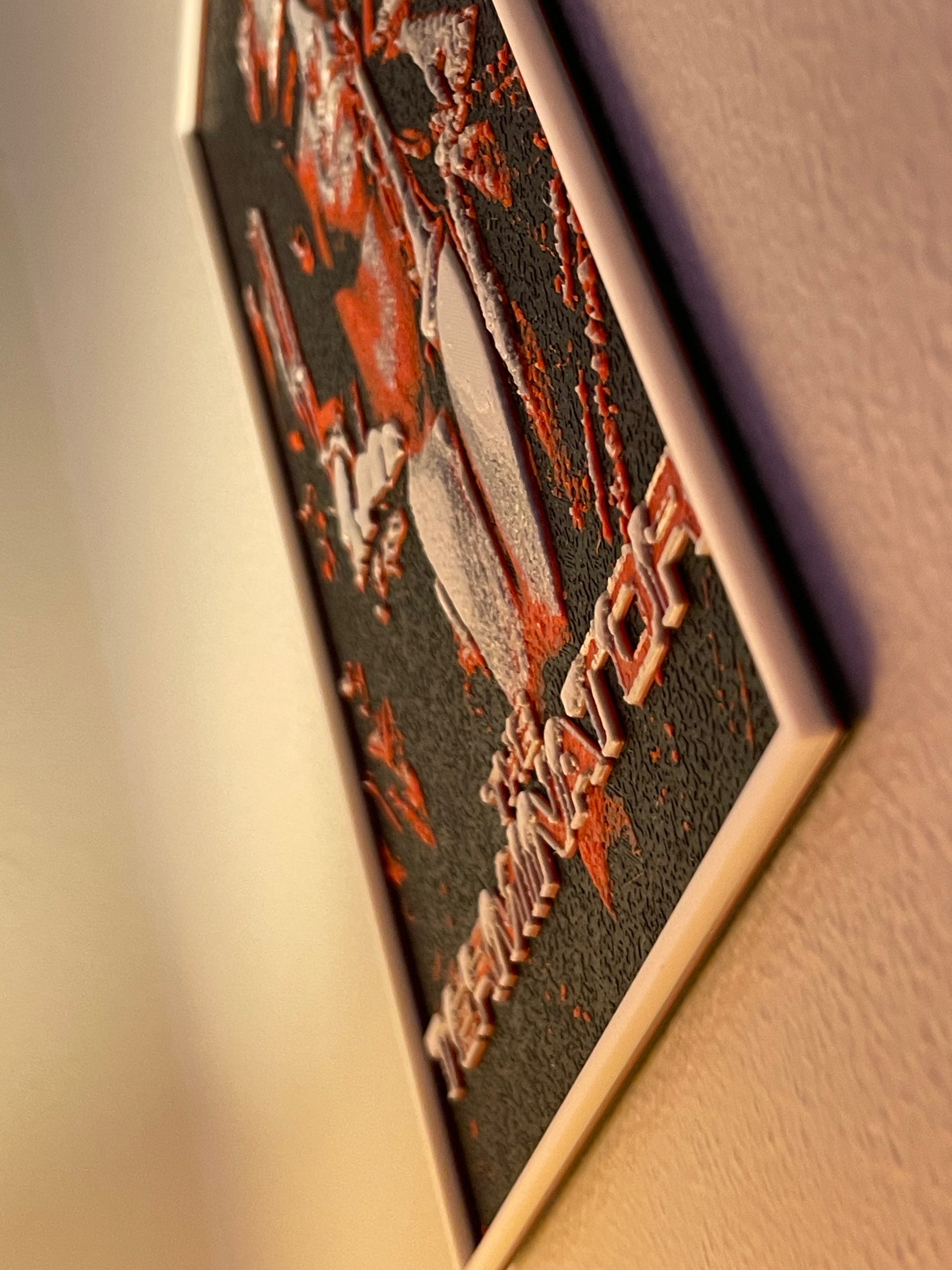 Close-up of a decorative plaque with intricate designs and text on a plain background