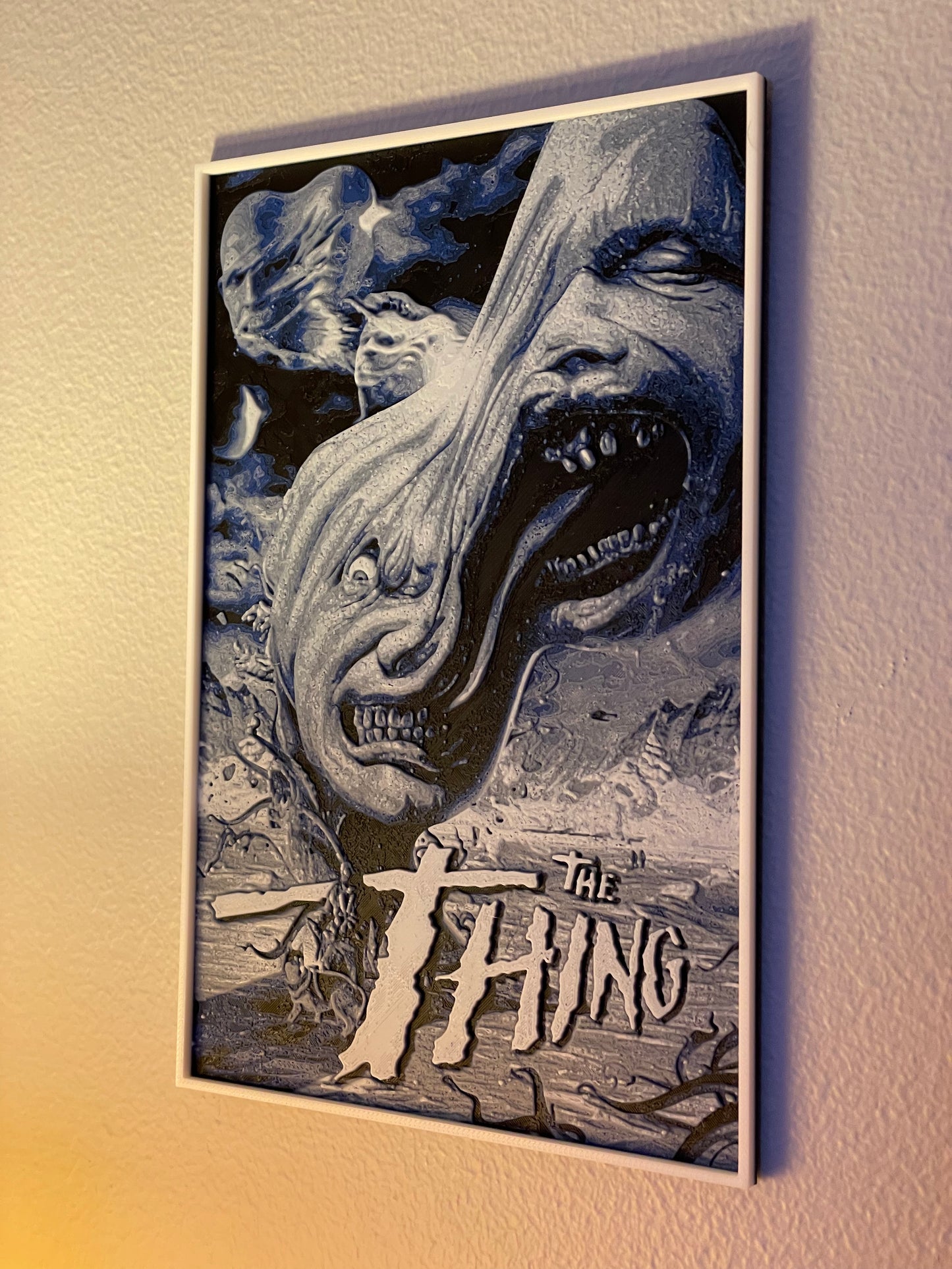 Framed poster of 'The Thing' with a creature and mountainous background.