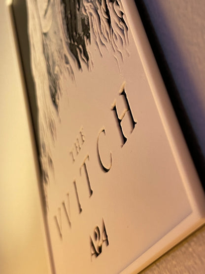 Decorative plaque with 'The Witch' text and number on a plain background