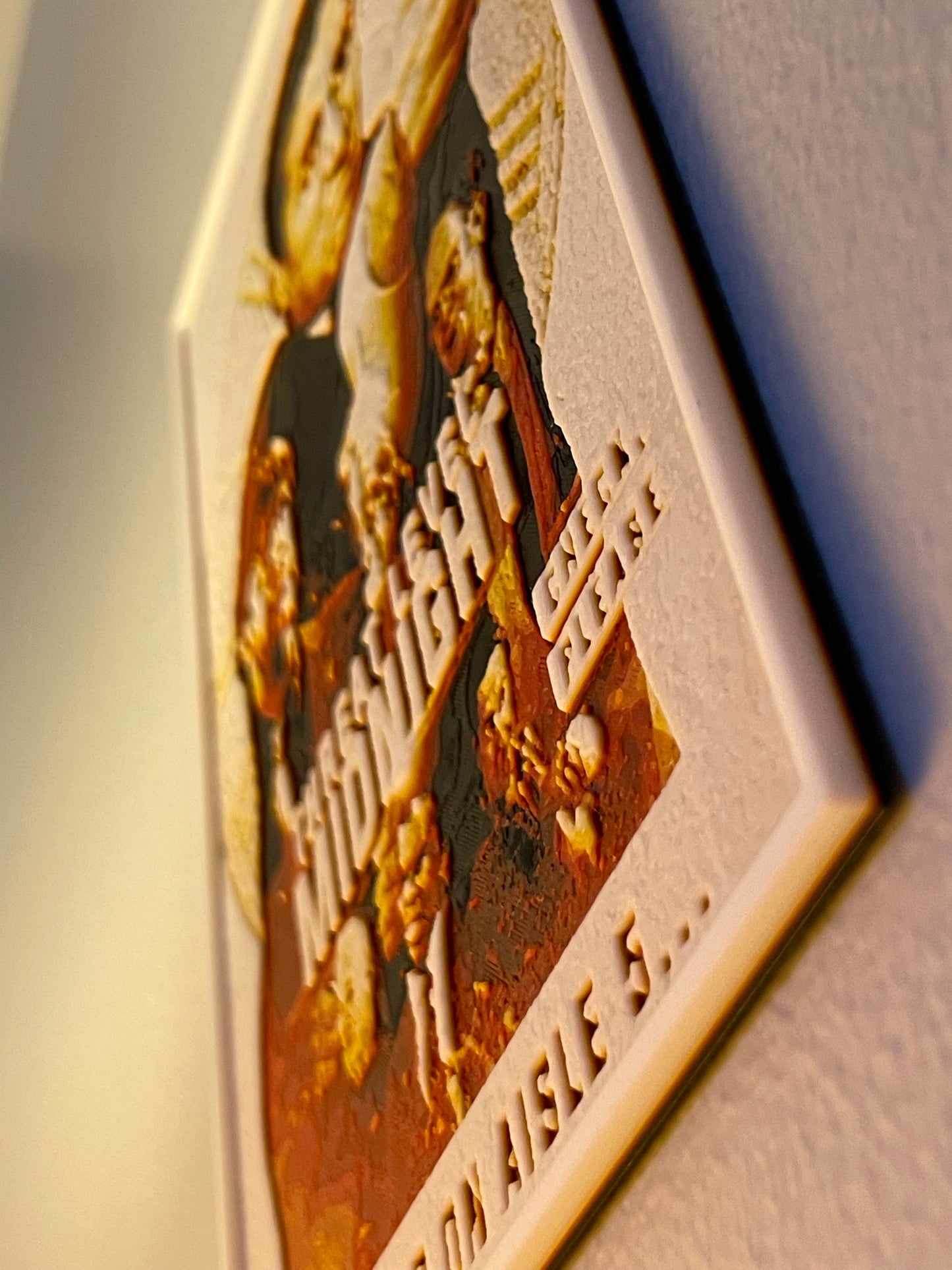 Decorative plaque with engraved text and design on a plain background