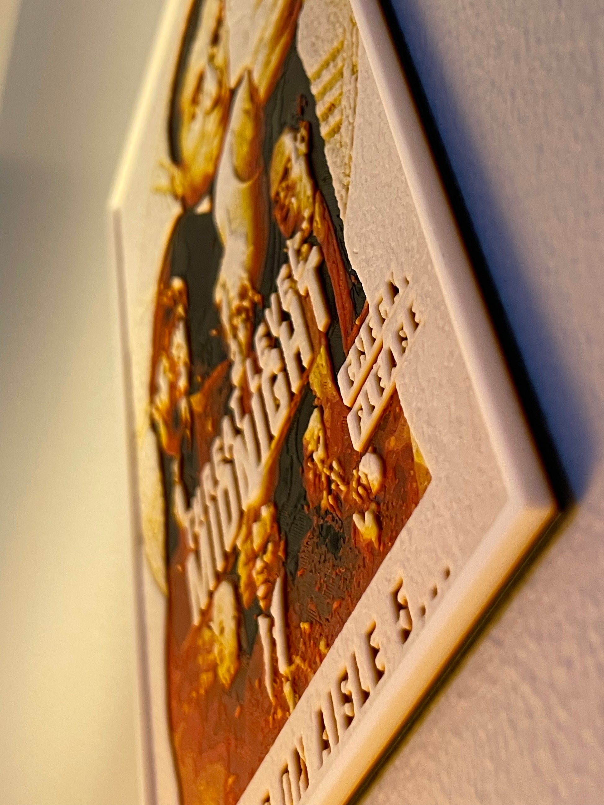 Decorative plaque with engraved text and design on a plain background