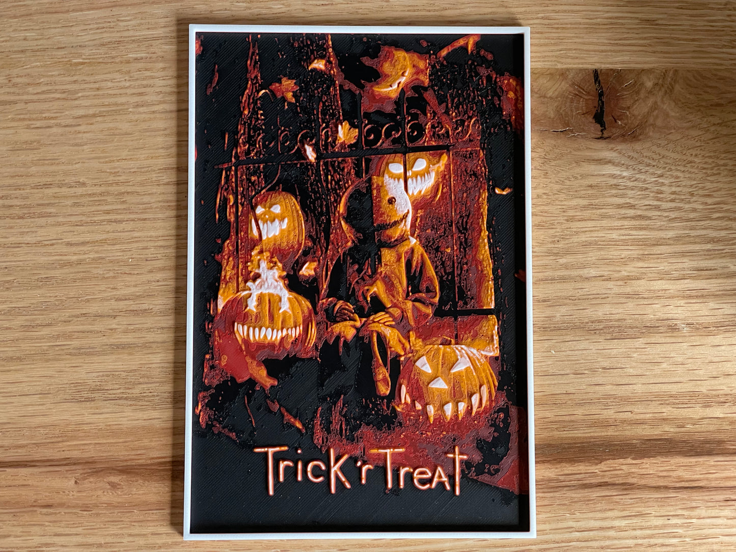 Poster of a character from 'Trick 'r Treat' with pumpkins on a wooden surface