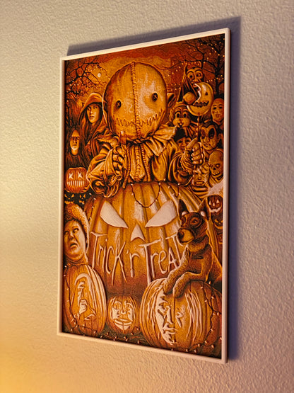 Wooden wall art with Halloween-themed design featuring pumpkins and faces on a plain wall.